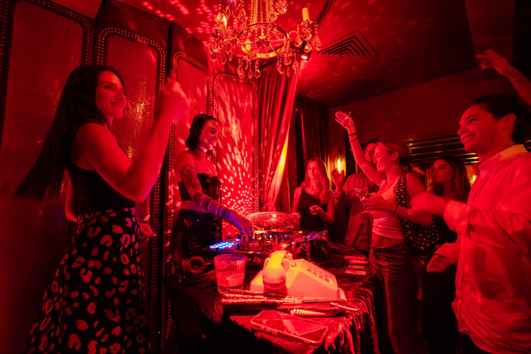 DJ booth at a party under red lights