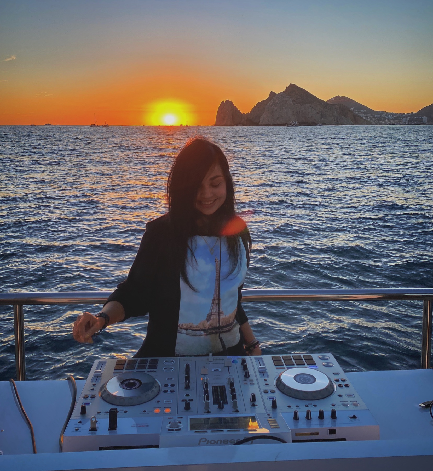 Guests celebrating on a private yacht charter off Land's End, Los Cabos